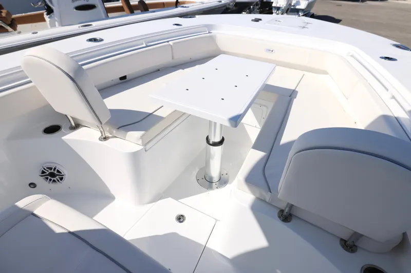Slide: The Image of 2026 Sea Hunt Gamefish 27 Forward Seating with table and cushioned seats. - 5