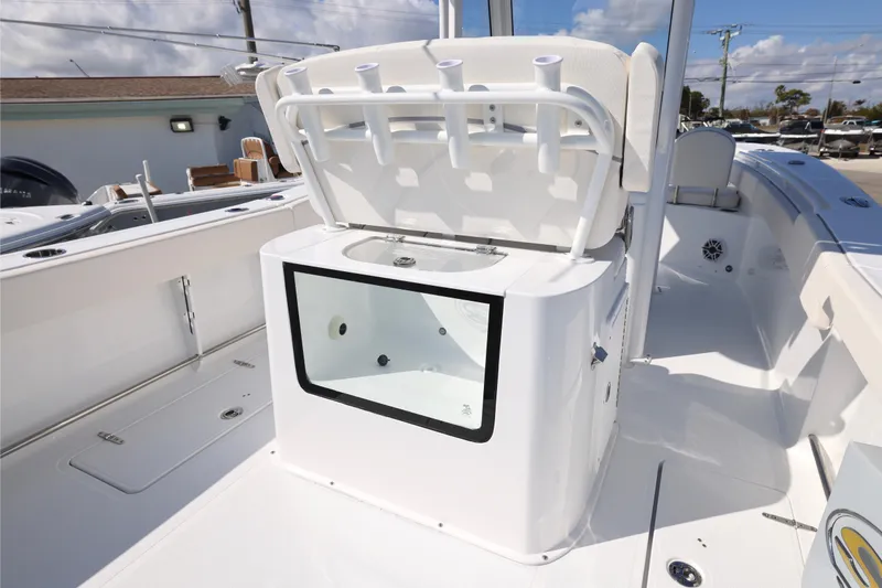 Slide: The Image of 2026 Sea Hunt Gamefish 27 Forward Seating boat interior with rod holders and storage compartment. - 6