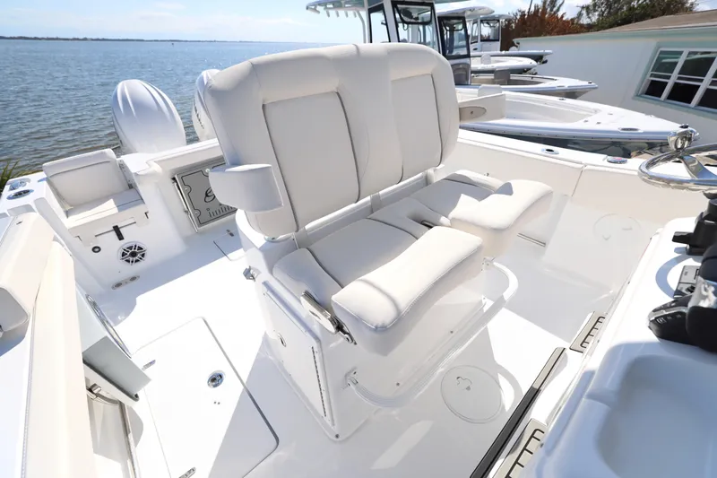 Slide: The Image of 2026 Sea Hunt Gamefish 27 Forward Seating boat interior with plush white seats and steering wheel. - 7