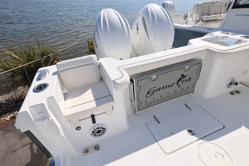 Slide: The Image of 2026 Sea Hunt Gamefish 27 boat with forward seating, featuring dual engines and sleek design. - 8