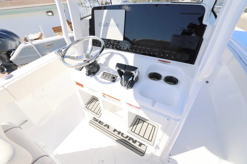 Slide: The Image of 2026 Sea Hunt Gamefish 27 helm with Garmin display and dual cup holders. - 9