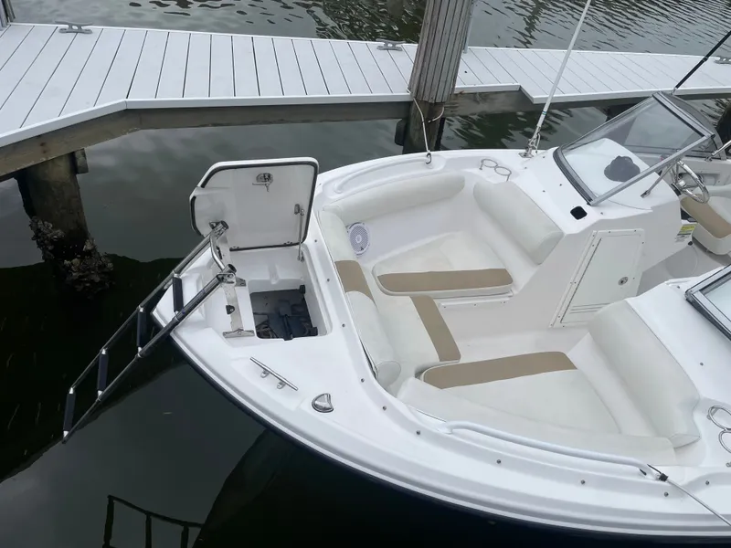 Slide: The Image of 2016 Edgewater 205CX Crossover at dock, open hatch and seating area. - 10