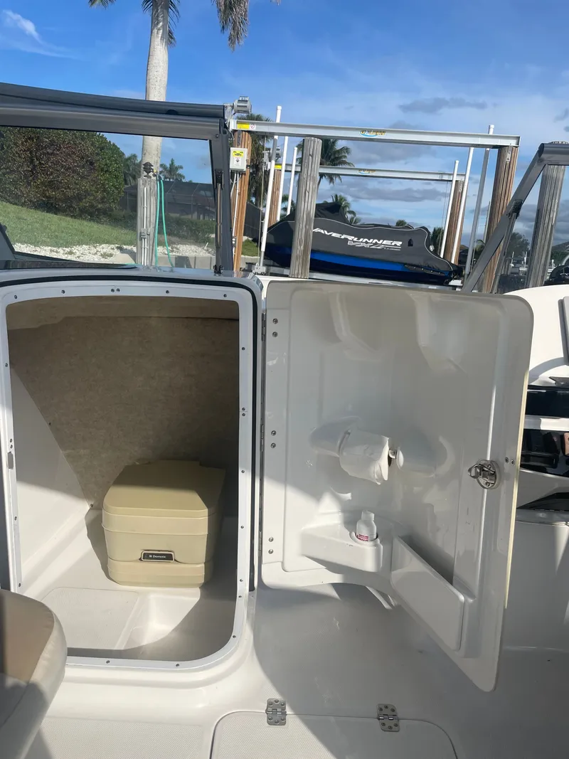 Slide: The Image of Interior of 2016 Edgewater 205CX Crossover with storage and toilet. - 12