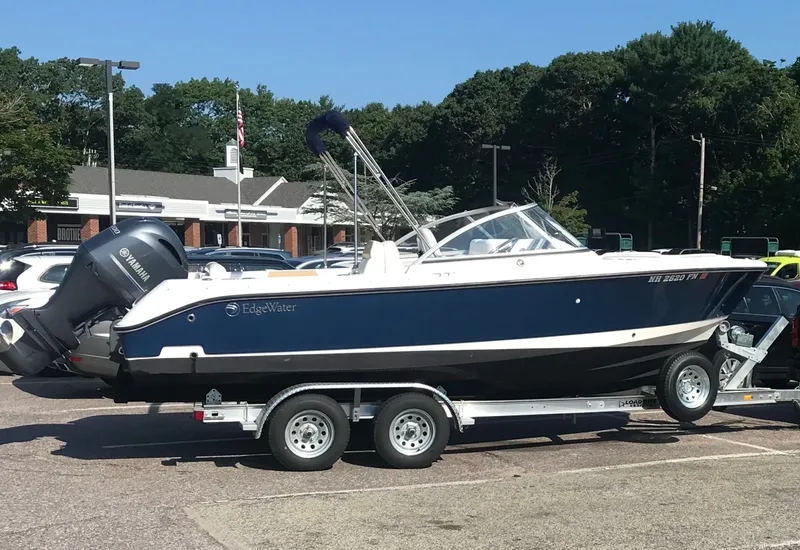 Slide: The Image of 2016 Edgewater 205CX Crossover boat on trailer parked outdoors. - 4