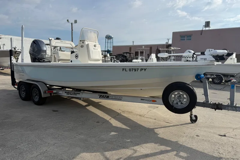 Slide: The Image of 2015 Pathfinder 2200 Tournament Edition boat on trailer in marina setting. - 12