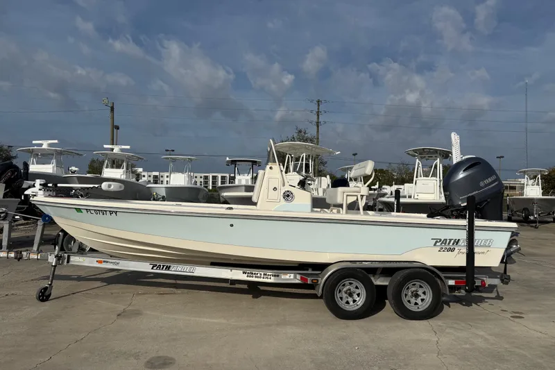 Slide: The Image of 2015 Pathfinder 2200 Tournament Edition boat on trailer, parked outdoors. - 17