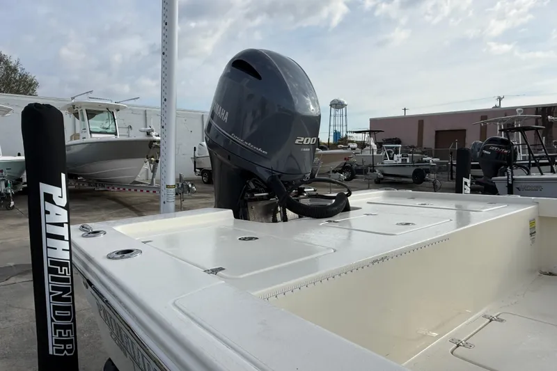 Slide: The Image of 2015 Pathfinder 2200 Tournament Edition boat with Yamaha 200 engine in marina setting. - 2