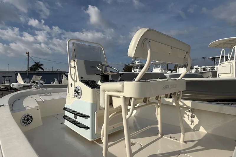 Slide: The Image of 2015 Pathfinder 2200 Tournament Edition boat with console and seating, under a partly cloudy sky. - 4