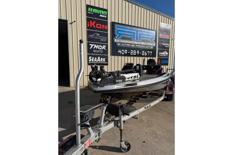 Slide: The Image of 2021 Bass Cat Lynx boat on trailer outside marine shop. - 13