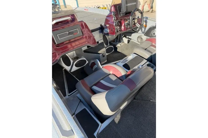 Slide: The Image of 2021 Bass Cat Lynx boat interior with red and gray seating and dashboard. - 4