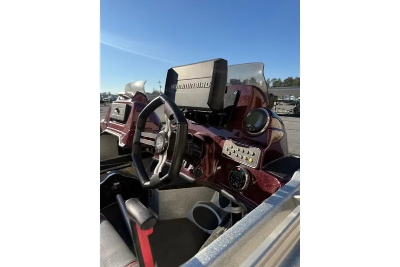 Slide: The Image of 2021 Bass Cat Lynx boat dashboard with steering wheel and Humminbird electronics. - 7