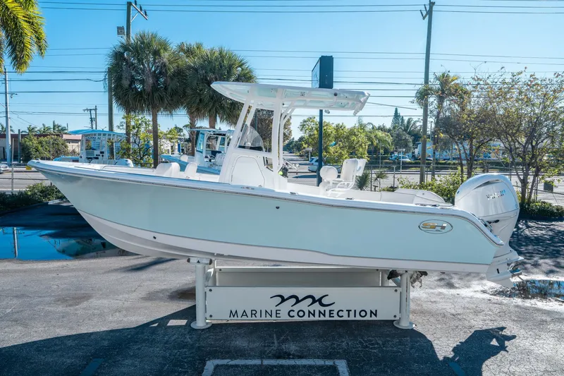 Slide: The Image of Sea Hunt Ultra 229 boat, 2026 model, displayed in a parking lot. - 4