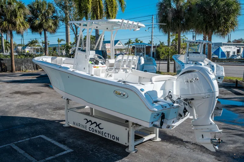 Slide: The Image of 2026 Sea Hunt Ultra 229 boat on a parking lot. - 3