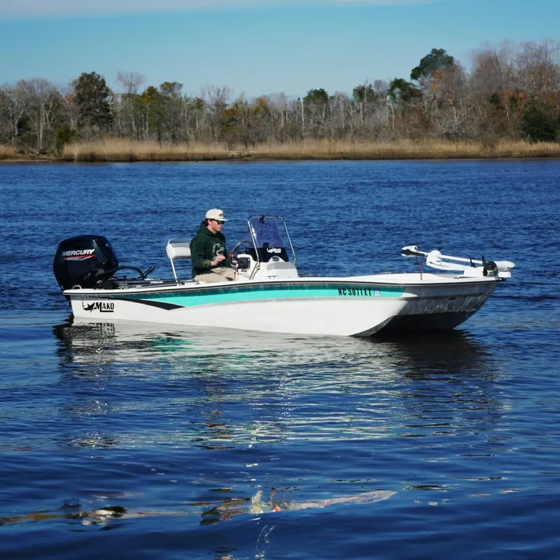 The Image of Mako Pro Skiff 17 CC 2021 on calm water with driver. - 0