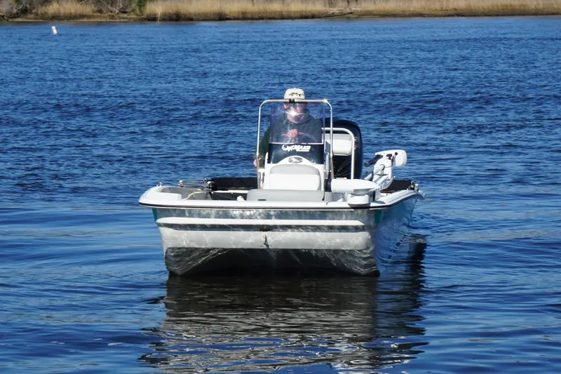 Slide: The Image of 2021 Mako Pro Skiff 17 CC boat on calm blue water. - 3