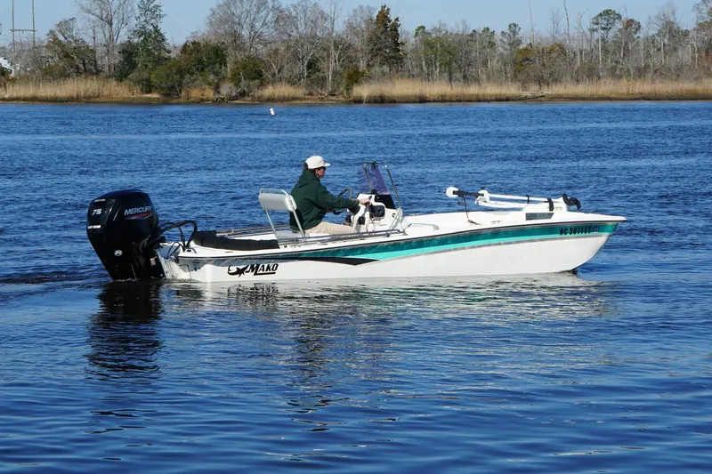 Slide: The Image of 2021 Mako Pro Skiff 17 CC boat on calm water with Mercury engine. - 5