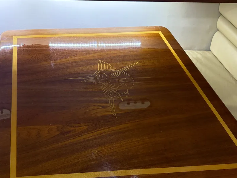 Slide: The Image of Wooden table with inlaid fish design on Pursuit 3400 Express, 2003. - 11