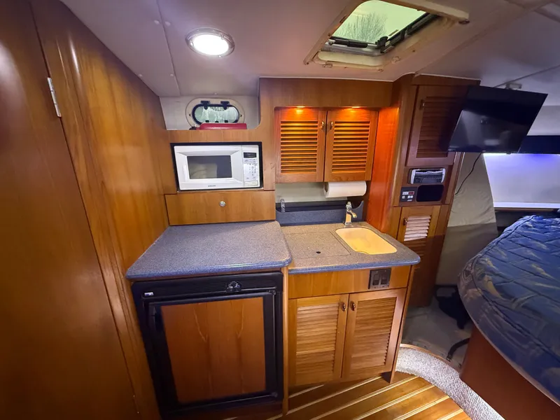 Slide: The Image of Interior of 2003 Pursuit 3400 Express with kitchen and sleeping area. - 14