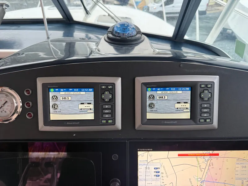 Slide: The Image of Dashboard of a 2003 Pursuit 3400 Express boat with SmartCraft displays. - 22