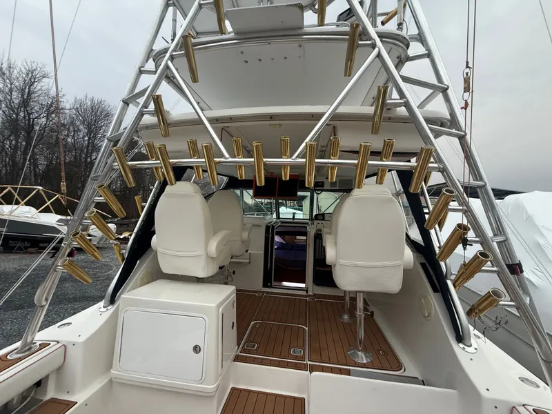 Slide: The Image of 2003 Pursuit 3400 Express boat with fishing rod holders and cockpit view. - 30