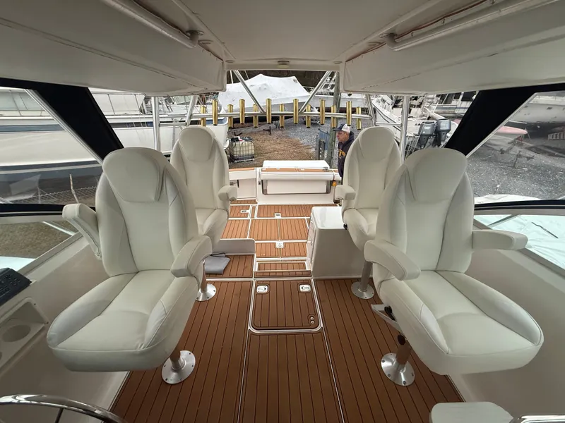 Slide: The Image of Interior of 2003 Pursuit 3400 Express with four white seats. - 31