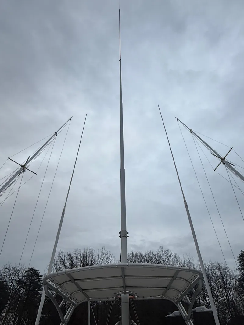 Slide: The Image of Masts of a 2003 Pursuit 3400 Express boat against cloudy sky. - 35