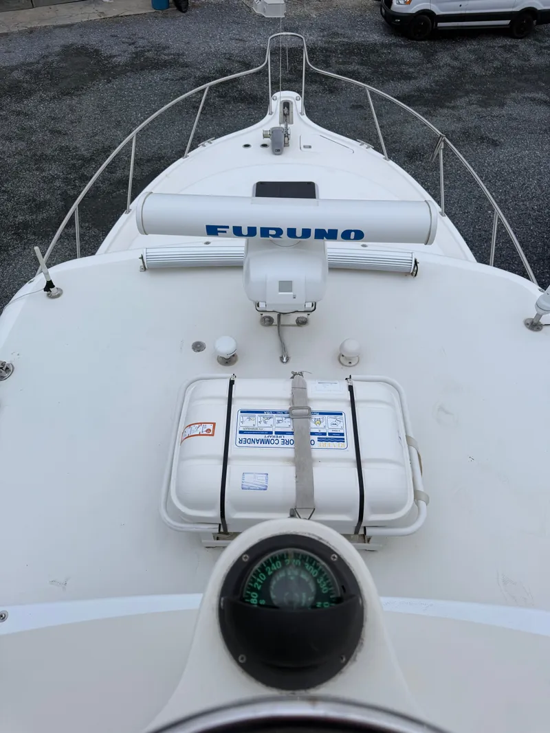 Slide: The Image of Deck view of 2003 Pursuit 3400 Express with compass and equipment. - 43