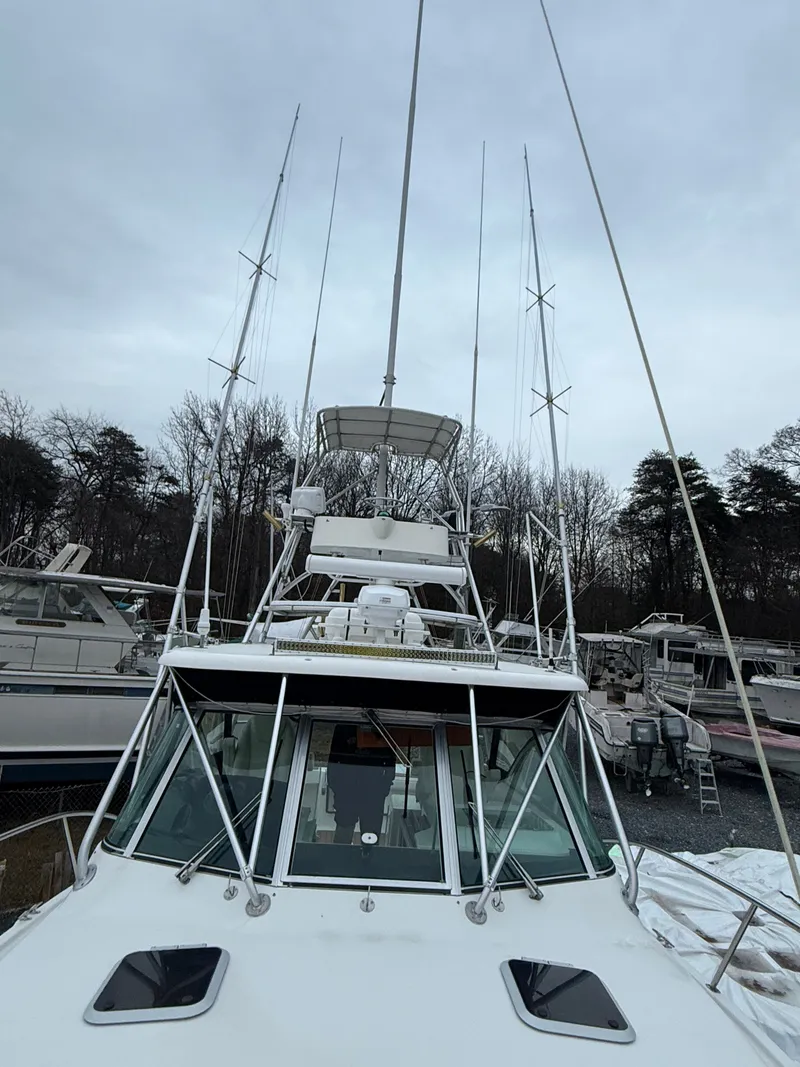 Slide: The Image of 2003 Pursuit 3400 Express boat docked, cloudy sky. - 44