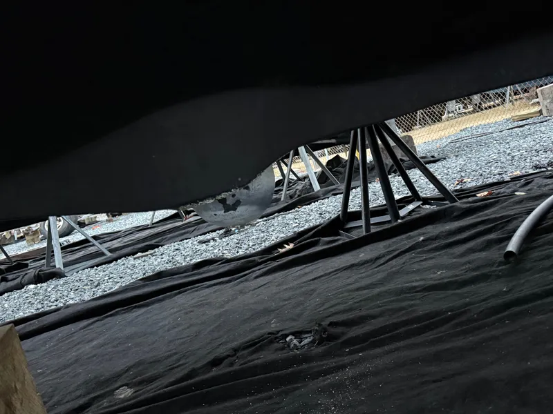 Slide: The Image of Underside of a Pursuit 3400 Express boat on stands. - 46