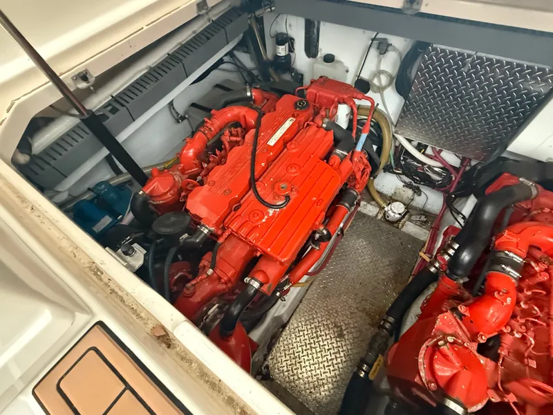 Slide: The Image of Engine room of a 2003 Pursuit 3400 Express with red engines. - 5