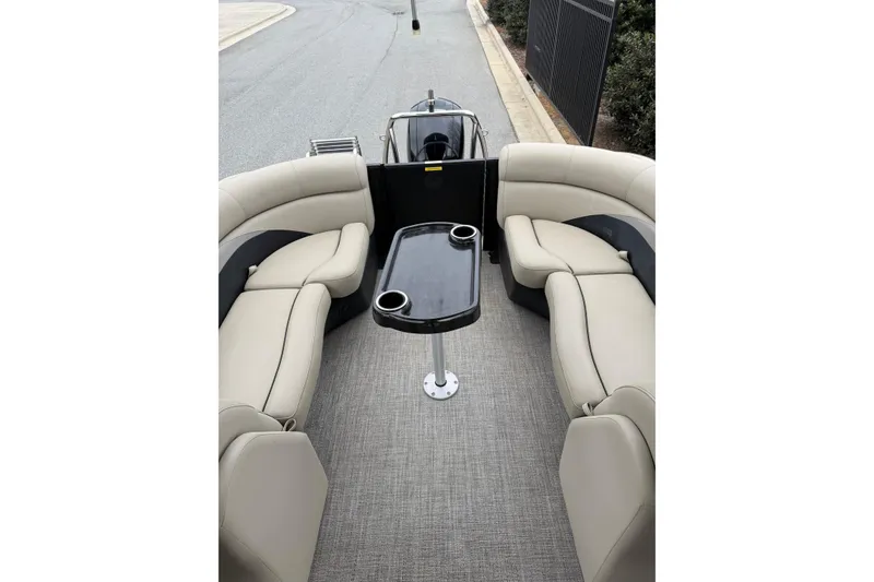 Slide: The Image of 2021 Barletta C22QC pontoon boat interior with beige seating and central table. - 14