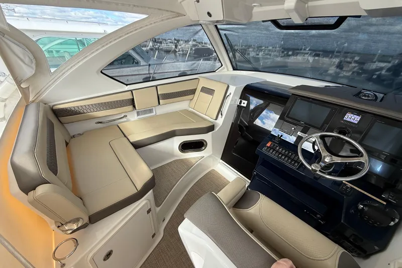 Slide: The Image of Interior of 2019 Pursuit OS 355 Offshore boat with helm and seating area. - 10