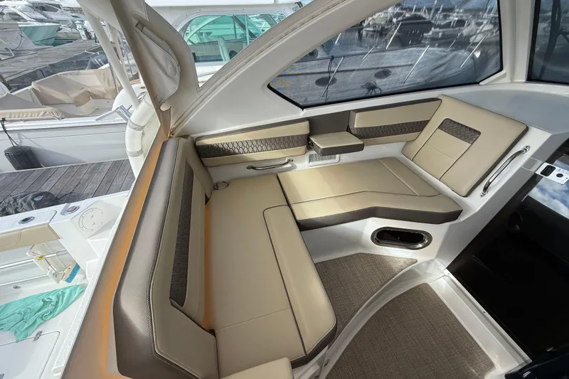 Slide: The Image of Interior of 2019 Pursuit OS 355 Offshore boat with seating and helm station. - 11