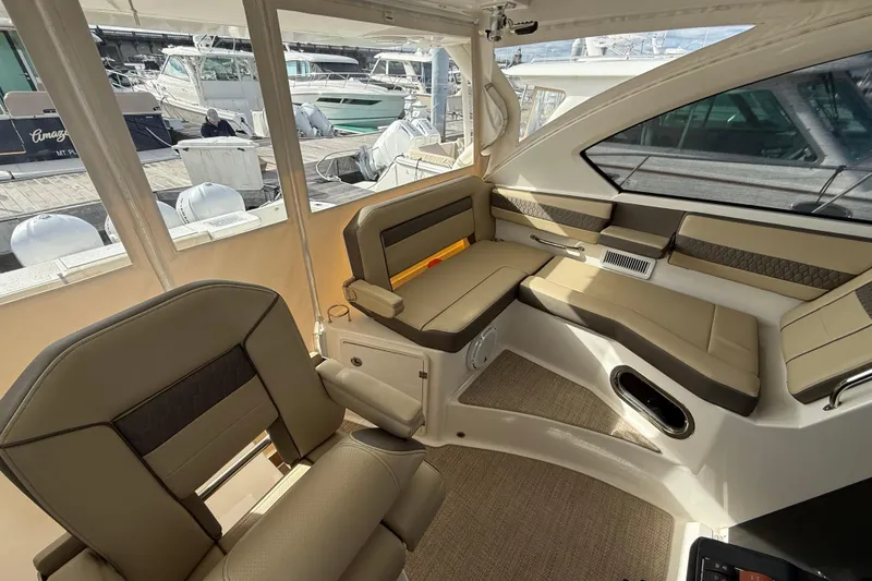 Slide: The Image of Interior of 2019 Pursuit OS 355 Offshore boat with seating and helm station. - 12