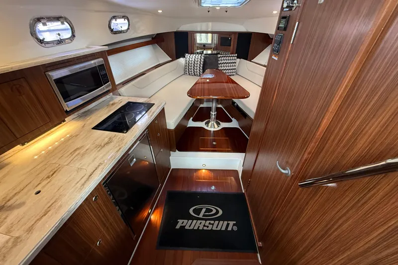 Slide: The Image of 2019 Pursuit OS 355 Offshore helm with navigation screens and controls. - 17