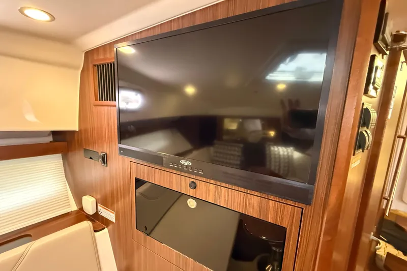 Slide: The Image of Luxurious interior of 2019 Pursuit OS 355 Offshore boat with plush seating and cushions. - 22