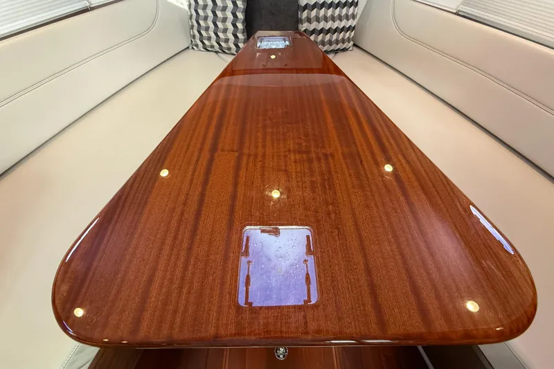 Slide: The Image of 2019 Pursuit OS 355 Offshore interior detail with cup holder and switch. - 23