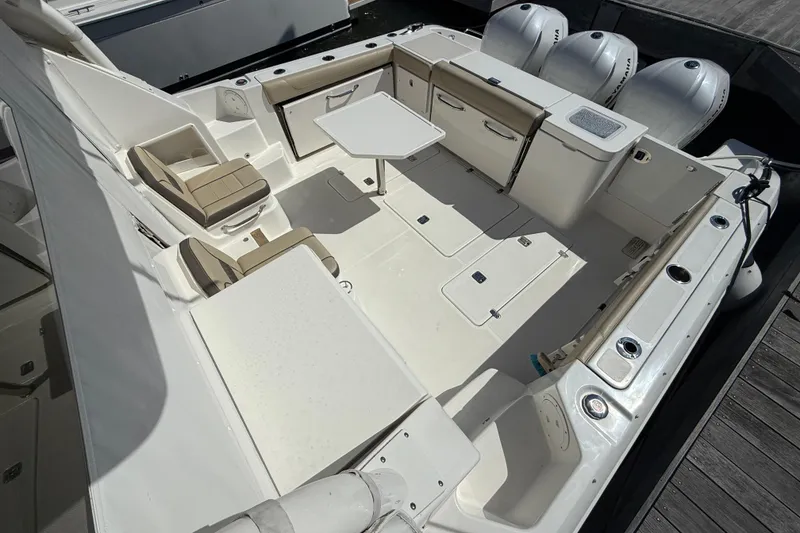 Slide: The Image of 2019 Pursuit OS 355 Offshore boat docked in marina under cloudy sky. - 3