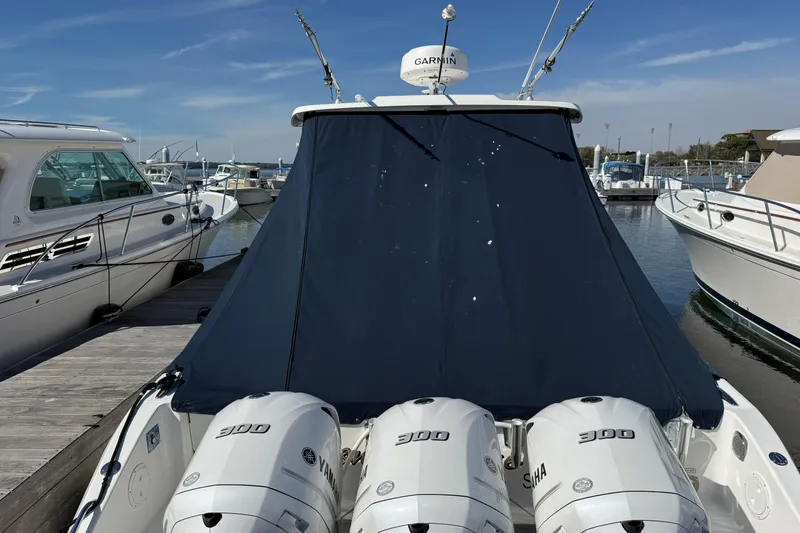 Slide: The Image of 2019 Pursuit OS 355 Offshore boat with triple Yamaha 300 engines docked at marina. - 39