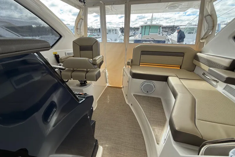 Slide: The Image of 2019 Pursuit OS 355 Offshore boat interior with seating and table setup. - 9