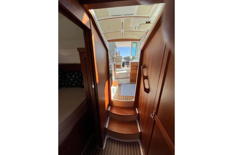 Slide: The Image of Interior view of 2017 Back Cove 37 yacht, featuring wooden stairs and cabin entrance. - 15