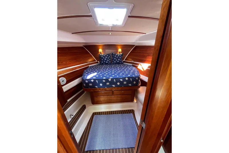 Slide: The Image of Cozy cabin interior of 2017 Back Cove 37 yacht with wooden accents and nautical bedding. - 5