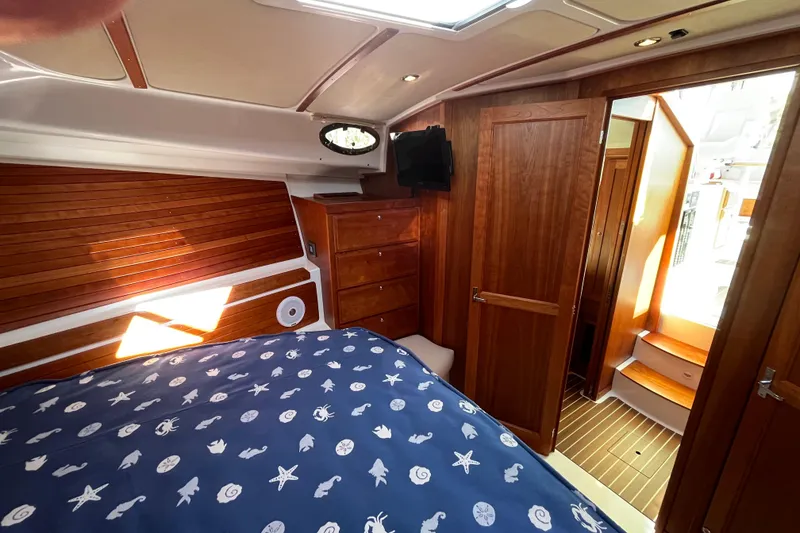 Slide: The Image of Luxurious cabin interior of 2017 Back Cove 37 yacht with wooden finishes and nautical bedding. - 6