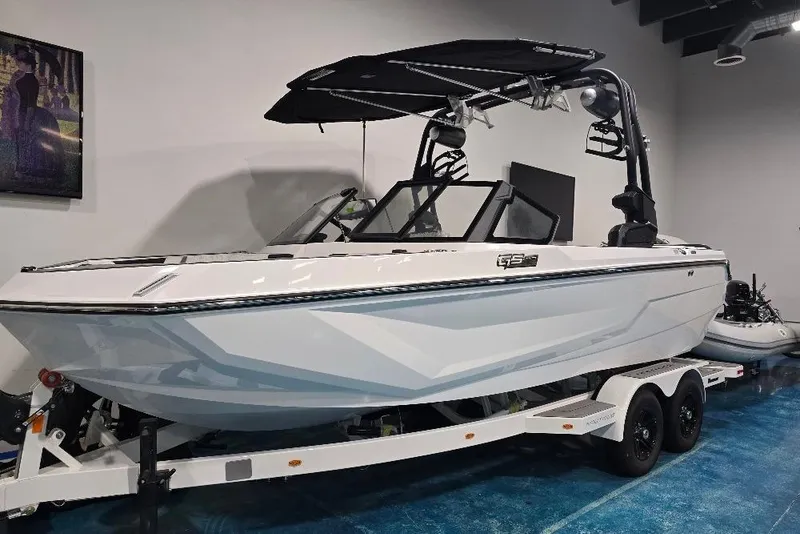 The Image of 2024 Nautique Super Air Nautique GS20 boat on trailer in showroom. - 9