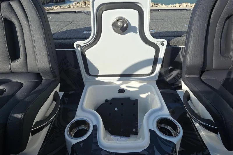 Slide: The Image of Interior of 2025 iKon LX21 boat with open storage compartment and cup holders. - 11