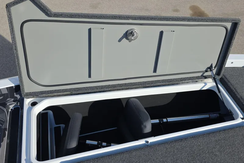 Slide: The Image of Open storage compartment in 2025 iKon LX21 boat, featuring hydraulic lift support. - 14