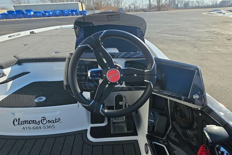 Slide: The Image of Steering wheel and dashboard of 2025 iKon LX21 boat, featuring modern controls and display. - 17