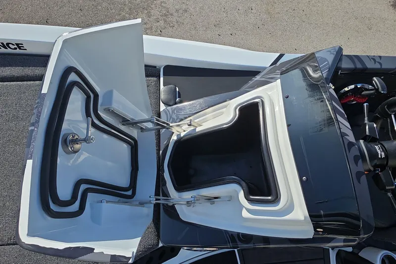 Slide: The Image of Open storage compartment on iKon LX21 boat, 2025 model, showing interior details and latch mechanism. - 19