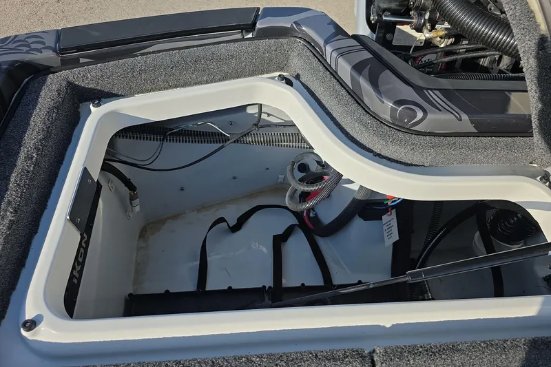 Slide: The Image of Open storage compartment of 2025 iKon LX21 boat, showcasing interior wiring and design. - 22