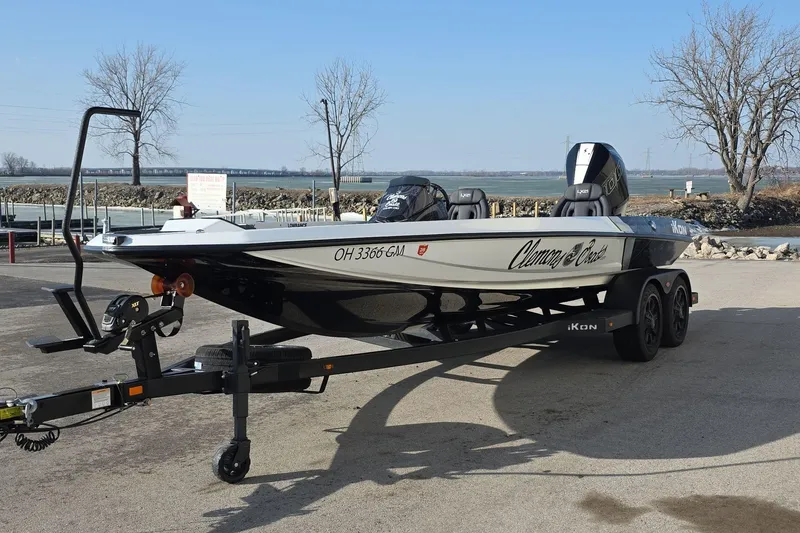 Slide: The Image of 2025 iKon LX21 boat on trailer, parked near waterfront, showcasing sleek design and modern features. - 3